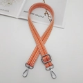 Close-up of orange and white herringbone woven canvas bag strap with silver metal hooks - Orange And White With Silver Hook