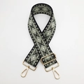 Detail of adjustable wide nylon shoulder strap with geometric diamond embroidery and gold hardware - Black and Olive Green With Gold Hook