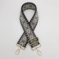 Close-up of geometric diamond pattern strap with polished gold metal hardware - Black and Gray With Gold Hook