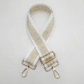 Detail of adjustable geometric diamond pattern wide nylon shoulder strap with gold lobster clasps - White Border Apricot With Gold Hook