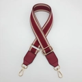 Macro detail of red herringbone woven strap with high-quality gold metal lobster clasps - Burgundy With Burgundy Leather