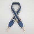 Detail of adjustable blue and beige herringbone woven bag strap with gold metal hardware - Lake Blue