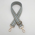 Close-up of adjustable blue and beige checkered woven bag strap with gold metal buckles - Light Blue Edge White + Gold Hook