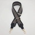 Close-up of adjustable geometric weave strap with gold metal buckles and leather ends - Gold Hook / Black Gray on Coffee Base/Black Leather