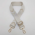 Detail of adjustable chevron weave shoulder strap with gold-tone lobster clasps - Beige + Gold Hook