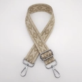Close-up of wide ethnic woven strap with beige diamond patterns and silver metal hooks - Khaki Gold Thread Arrow + Silver Hook