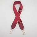 Close-up of wine red nylon bag strap showing twill texture and gold metal D-ring hardware - Burgundy With Burgundy Leather
