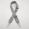 Close-up of grey nylon bag strap with gold metal D-ring and rotating lobster clasps - Light Grey with Light Grey Leather