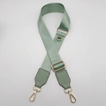 Detail of mint green nylon bag strap with gold metal D-ring and swivel lobster clasps - Matcha Green with Matcha Green Leather