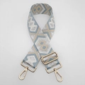 Detail view of adjustable ethnic nylon bag strap with blue geometric weave and gold hooks - Light Blue and Khaki with Silver Thread and Gold Hook
