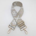 Close-up of ethnic style nylon bag strap with gold metal hooks and geometric patterns - Beige and Off-White with Silver Thread and Gold Hook