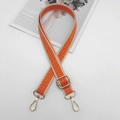 Close-up of orange geometric patterned bag strap with golden metal lobster clasps - Gold Hook / Beige Edge Orange