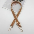 Detail of adjustable bag strap with jacquard geometric pattern and gold hardware - Gold Hook / Beige Edge Brown