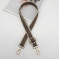 Close-up of adjustable woven strap with dark floral patterns and gold metal lobster clasps - Gold Hook / Beige Edge Light Coffee