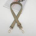 Detail of adjustable woven canvas strap in bean green with vintage geometric patterns - Gold Hook / Green Edge Khaki