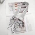 Detail of silver gray adjustable bag strap with Fashion & Classic lettering and metal hooks - Letter Style