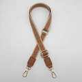 Close-up of geometric jacquard bag strap with brown leather ends and gold metal buckles - Beige Border Brown + Brown Leather