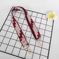 Tracolla regolabile in tela con motivo geometrico rosso e beige e ganci in metallo dorato - Gancio oro chiaro / Borgogna