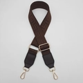 Close-up of wide geometric pattern bag strap with brown leather and gold metal buckles - Coffee + Coffee Leather