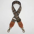 Close-up of vintage ethnic embroidery bag strap with bronze metal hooks and brown leather - No.4 Brown Leather