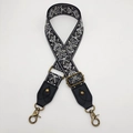 Detail view of retro jacquard wide bag strap with bronze metal hooks and floral pattern - Style 5 Black Leather