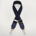 Detail of blue jacquard bag strap with geometric patterns and gold metal lobster clasps - Blue + Blue Leather