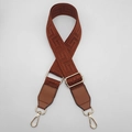 Close-up of adjustable brown woven shoulder strap with gold hardware and greek key pattern - Brown + Brown Leather