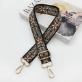 Close-up of bohemian geometric jacquard bag strap with gold metal hardware on magazine - Dark Brown on Black