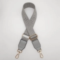 Detail of grey Greek key pattern strap with golden metal swivel hooks and buckles - Light Gray + Light Gray Leather