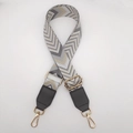 Detail of adjustable woven canvas strap with grey wave pattern and gold metal hooks - Dark Grey Apricot + Dark Grey Leather