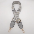 Macro shot of adjustable herringbone woven bag strap with grey faux leather and gold buckles - Dark Grey Apricot + Grey Leather