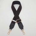Close-up of wide herringbone webbing strap with dark brown leather ends and gold metal hooks - Coffee + Coffee Leather Trim