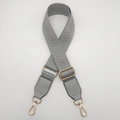 Detail of grey herringbone pattern canvas bag strap with gold metal lobster clasps - Grey + Grey Leather
