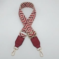 Detail of red geometric canvas shoulder strap with gold metal buckles and leather ends - Beige Base Wine Red + Wine Red Leather