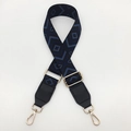 Detail showing blue and black diamond jacquard strap with gold metal swivel snap hooks - Black Base Blue + Black Leather