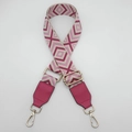 Close-up of geometric diamond pattern wide canvas bag strap with gold metal swivel hooks - Beige Rose Red + Rose Red Leather