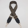 Detail view of wide adjustable canvas strap with gold lobster clasps and diamond pattern - Black/Khaki Pattern With Black Leather