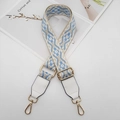 Close-up of bohemian blue floral jacquard strap with white leather and gold hardware - Beige Light Blue White + White Leather