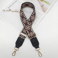Detail view of ethnic jacquard bag strap with golden buckles and black leather ends - Black Wine Red + Black Leather