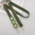 Detail view of army green woven crossbody strap with three yellow-centered crochet daisies - Army Green With Patch