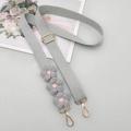 Close-up of adjustable grey woven shoulder strap with crochet flowers and gold lobster clasps - Gray With Patch