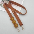 Close-up of brown crochet flower crossbody strap with golden lobster clasps and buckles - Brown With Patch
