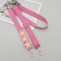 Detailed view of pink woven bag strap with handmade crochet flower accents and gold metal hooks - Deep Pink With Patch