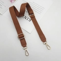 Detailed view of brown woven bag strap with golden metal lobster clasps and hardware - Brown