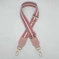 Close-up of adjustable striped canvas strap with pink leather ends and gold metal hooks - Pink (Pink Leather)