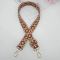 Detail view of 2.5cm geometric embroidered strap with golden metal lobster clasps - Light Blue Red Brown