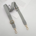 Detail of grey adjustable cotton strap with golden metal buckles and faux leather ends - Gray