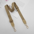 Detailed view of khaki canvas strap with gold swivel hooks and adjustable buckle on white surface - Khaki