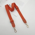 Adjustable orange cotton bag strap with golden hooks and leather ends on white desk - Orange