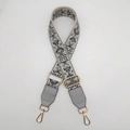 Detail of adjustable ethnic style bag strap with floral embroidery and gold metal hooks - Beige/Gray With Gold Hook